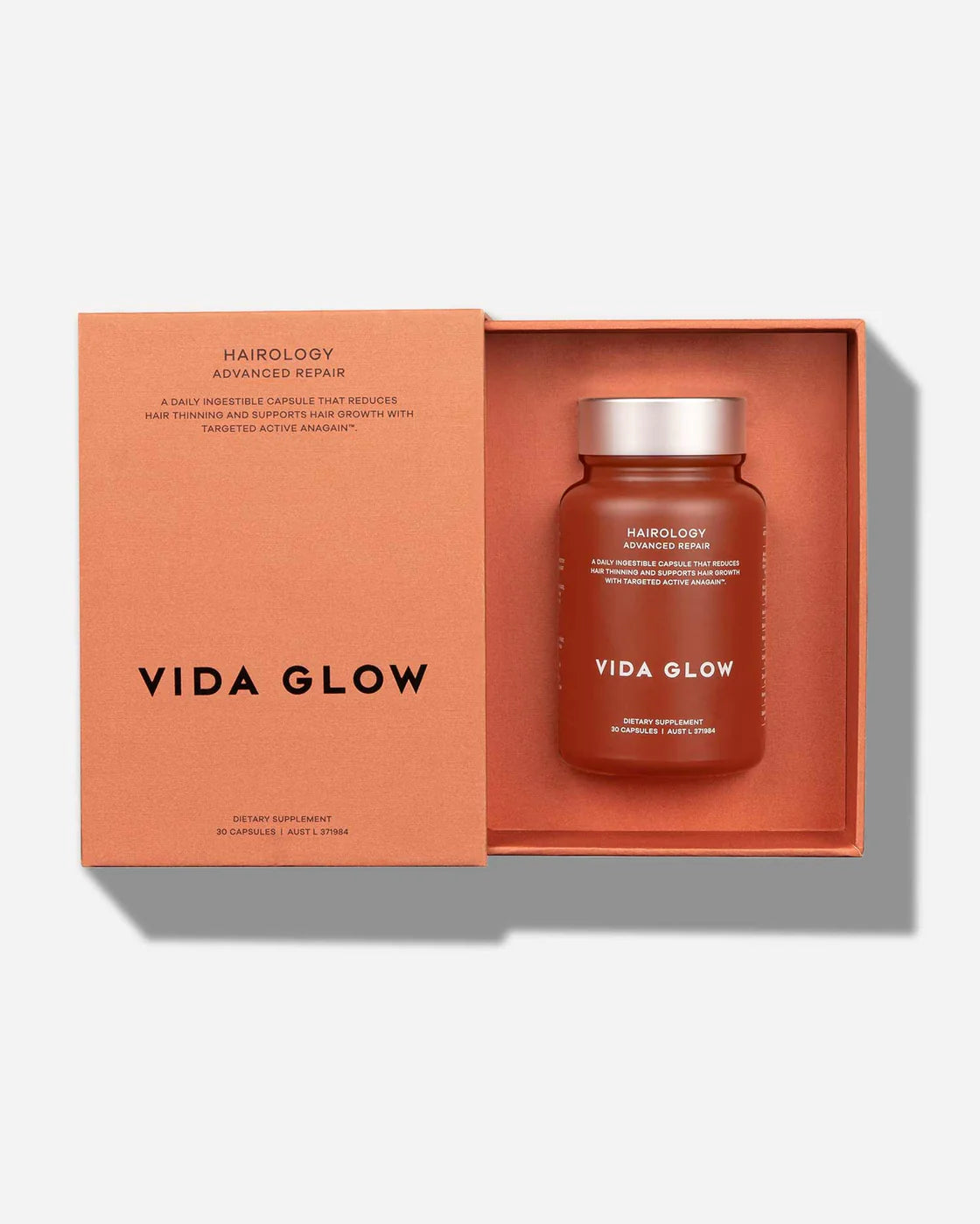 Open box of Vida Glow Hairology Advanced Repair Capsules showcasing the product bottle.