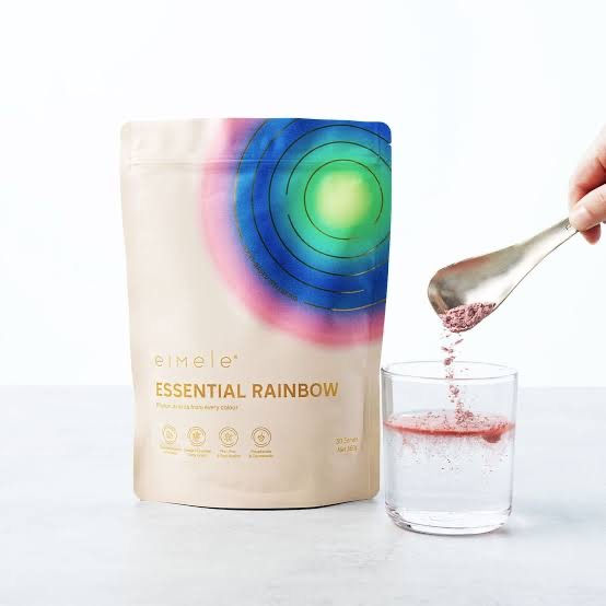 Preparing a glass of Eimele Essential Rainbow Superfood Powder